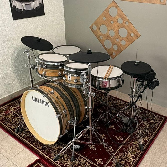 Drum set in a room with posters on the wall